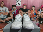 Front view of white lace-up basketball shoes with textured uppers