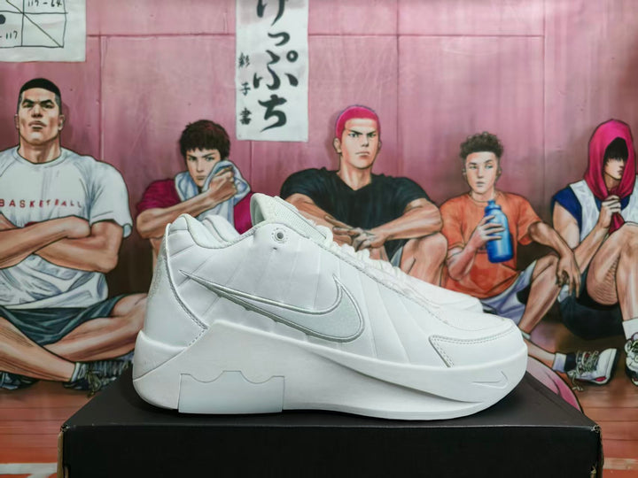 Side view of a white Nike basketball-style sneaker showing the layered upper, side Swoosh, padded collar, and sculpted sole.