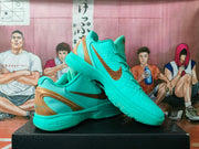 Angled display of the turquoise and gold basketball sneakers, showing the side panels, heel structure, and outsole.