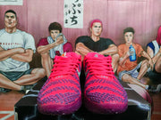 Front view of purple-red Nike basketball sneakers with matching laces and patterned toe boxes.