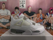 Side profile of one white and gray high-top sneaker showing its layered panels, mesh section, and speckled midsole.