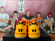 Rear view of the yellow Nike basketball shoes with black heel details.