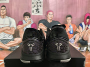 Rear view showing the patterned heel panels, black collars, and basketball-player emblems.