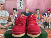Front view of red lace-up sneakers showing the tongues, matching laces, and textured cream-colored outsoles.