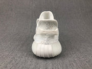 Rear view of the white sneaker highlighting the heel construction and ribbed sole.