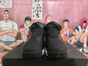 Front view showing the black padded tongues, raised collars, textured uppers, and black outsoles.