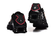 Rear views of black Nike Shox TL sneakers showing the heel and column-style sole