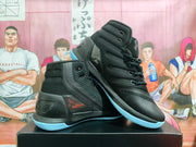 Angled view of black high-top basketball shoes showing the Under Armour branding, textured side panels and contrasting light-blue outsoles.