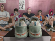 Rear view of the sneakers showing Nike heel branding, orange triangular details, and layered heel construction.