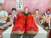 Front view showing the red textured uppers, red laces, and gold logo detail.