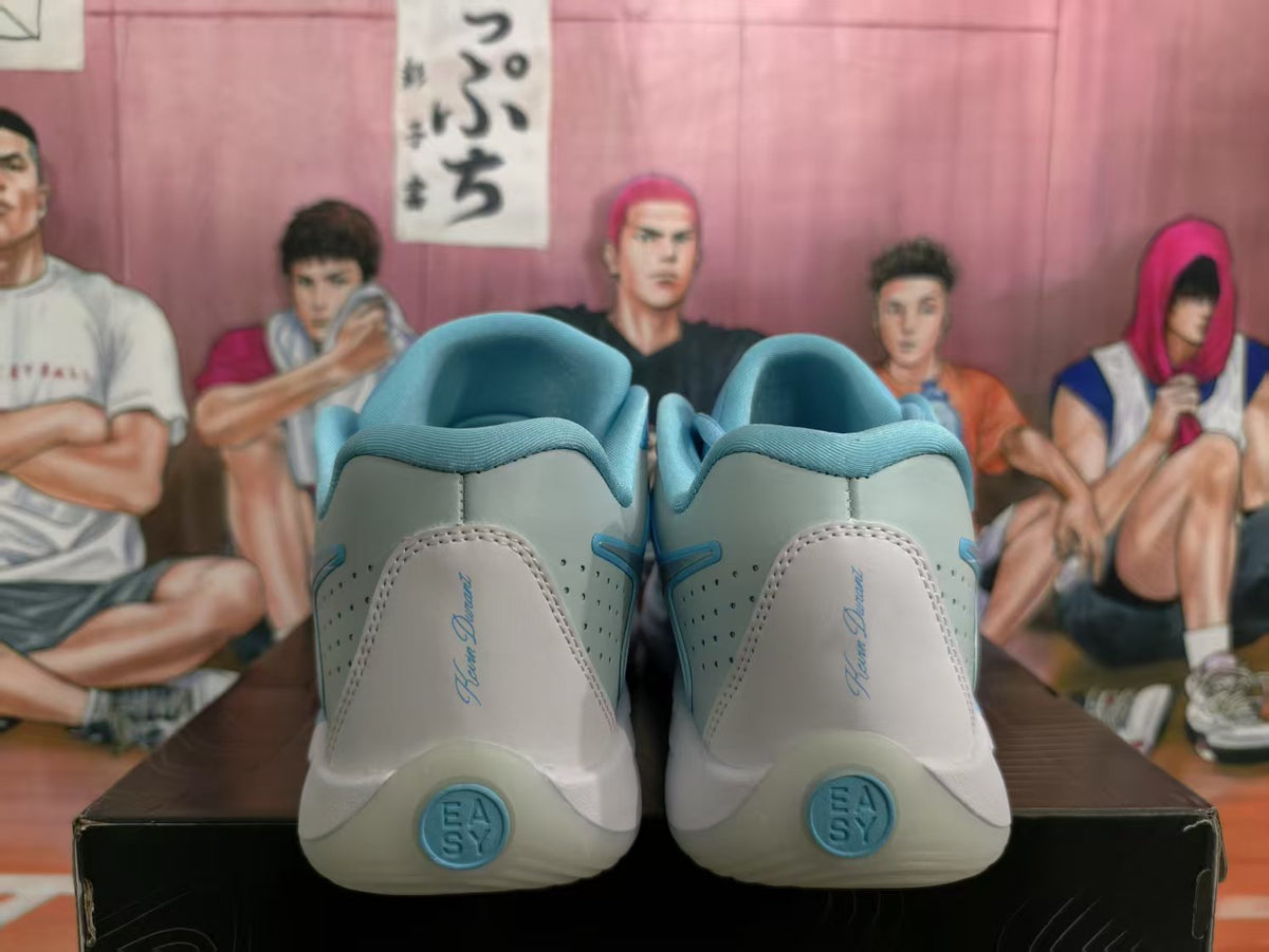 Rear view of ice blue and grey Nike basketball sneakers showing padded collars, heel detailing, and blue outsole accents.