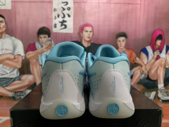 Rear view of ice blue and grey Nike basketball sneakers showing padded collars, heel detailing, and blue outsole accents.