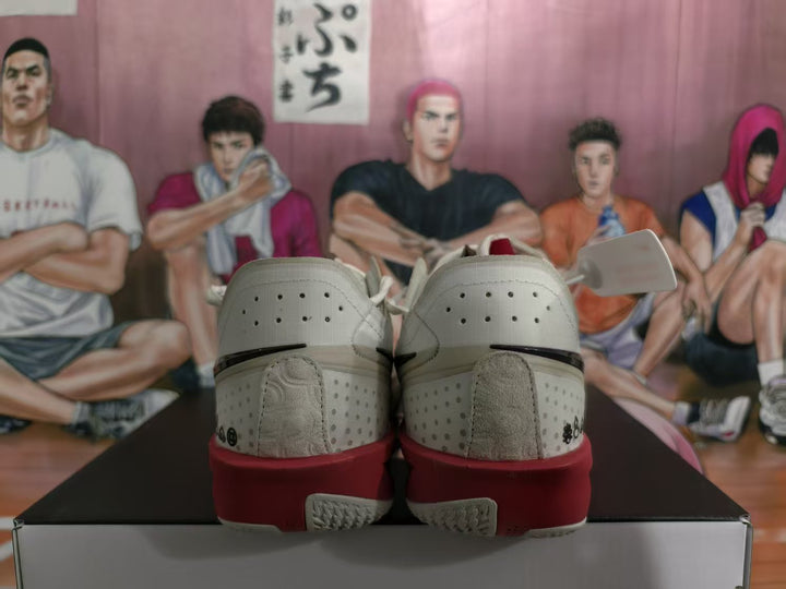 Rear view of white Nike basketball shoes with red midsoles and perforated heel panels