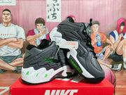 Pair of black and carbon gray Nike high-top sneakers with fluorescent green accents displayed on a red Nike shoebox.