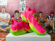 Angled view showing the pink and neon green Under Armour sneakers, laces, side panels, and textured soles.