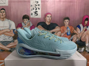 Side view of a blue basketball sneaker with a glossy patterned panel
