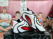 Angled view showing the Jumpman logo, red side panels, black overlays, and white upper.