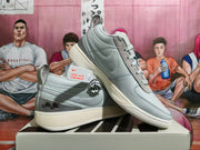 Angled view of the pair highlighting the grey side panels, heel details, and light-colored soles.