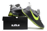 Smoke grey and black sneaker pair shown with one shoe lifted beside a black shoebox.