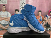 Angled view of blue Nike high-top basketball sneakers showing the padded collars, structured side panels and white textured soles.