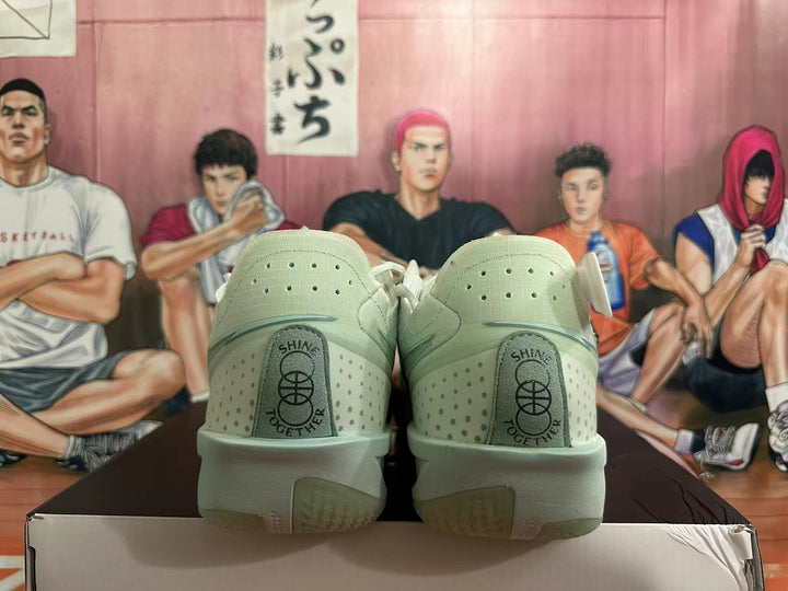 Rear view of pale green Nike basketball shoes with perforated panels and heel tabs marked SHINE TOGETHER.