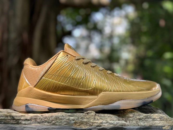 Side view of metallic gold Nike Kobe 5 basketball shoe