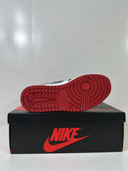 Red rubber outsole shown from below with circular traction detailing.