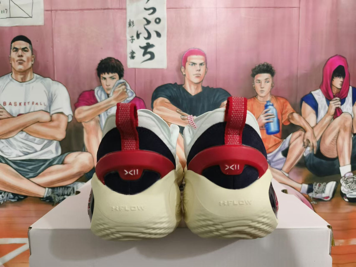 Rear view of white Kai basketball shoes with red heel details and a dark heel lining.