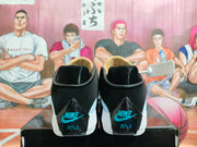 Rear view of the pair showing black heel panels with turquoise Nike branding.