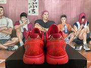 Rear view of red sneakers showing translucent heel panels and gold heel detailing.