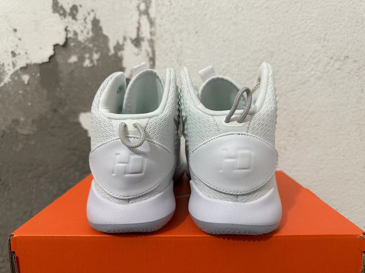 Rear view of a pair of white Nike high-top basketball shoes with textured collars and heel panels.
