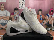 Angled side view showing the white Swoosh, textured upper, black side panel, and layered outsole.