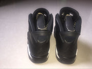 Rear view of the black high-top sneakers showing padded collars, heel tabs, and Jordan Air branding.
