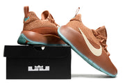 Brown sneaker shown at an angle beside a black shoebox.