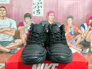 Front view of black Nike high-top sneakers showing padded tongues, laces, purple AIR lettering, and textured toe areas.