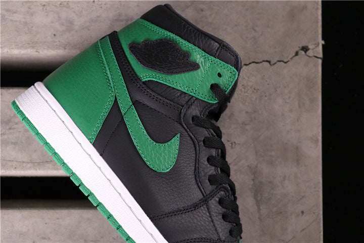 Close-up of the black and green high-top sneaker showing the ankle logo, green Swoosh, and white midsole.