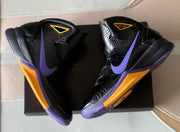 Overhead view of the pair highlighting black uppers with purple and gold details