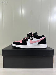 Side view of a black, white, and pink Jordan low-top sneaker displayed on a black shoebox.