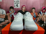 Front view of the white Nike shoes showing mesh-look toe boxes, laces, and textured outsoles.