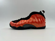 Black and orange high-top sneaker with a glossy orange side panel.