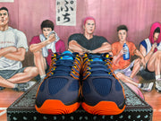 Top-front view of navy Nike basketball sneakers with orange and yellow accents