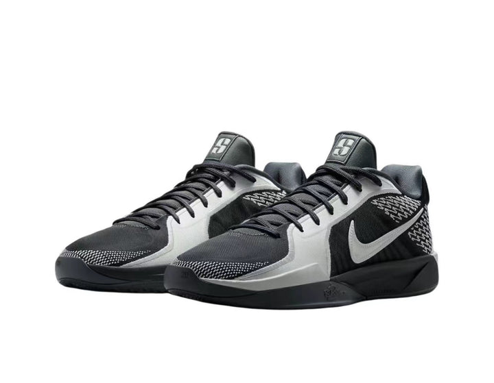Pair of gray, white and black Nike lace-up sneakers shown from a three-quarter side angle.