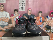 Front view of the Nike sneakers showing black laces, patterned upper panels, and cream-colored midsole edges.