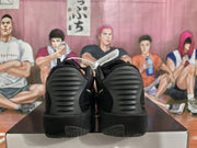 Rear view of black Nike basketball sneakers showing textured heel panels and patterned outsoles on a box.