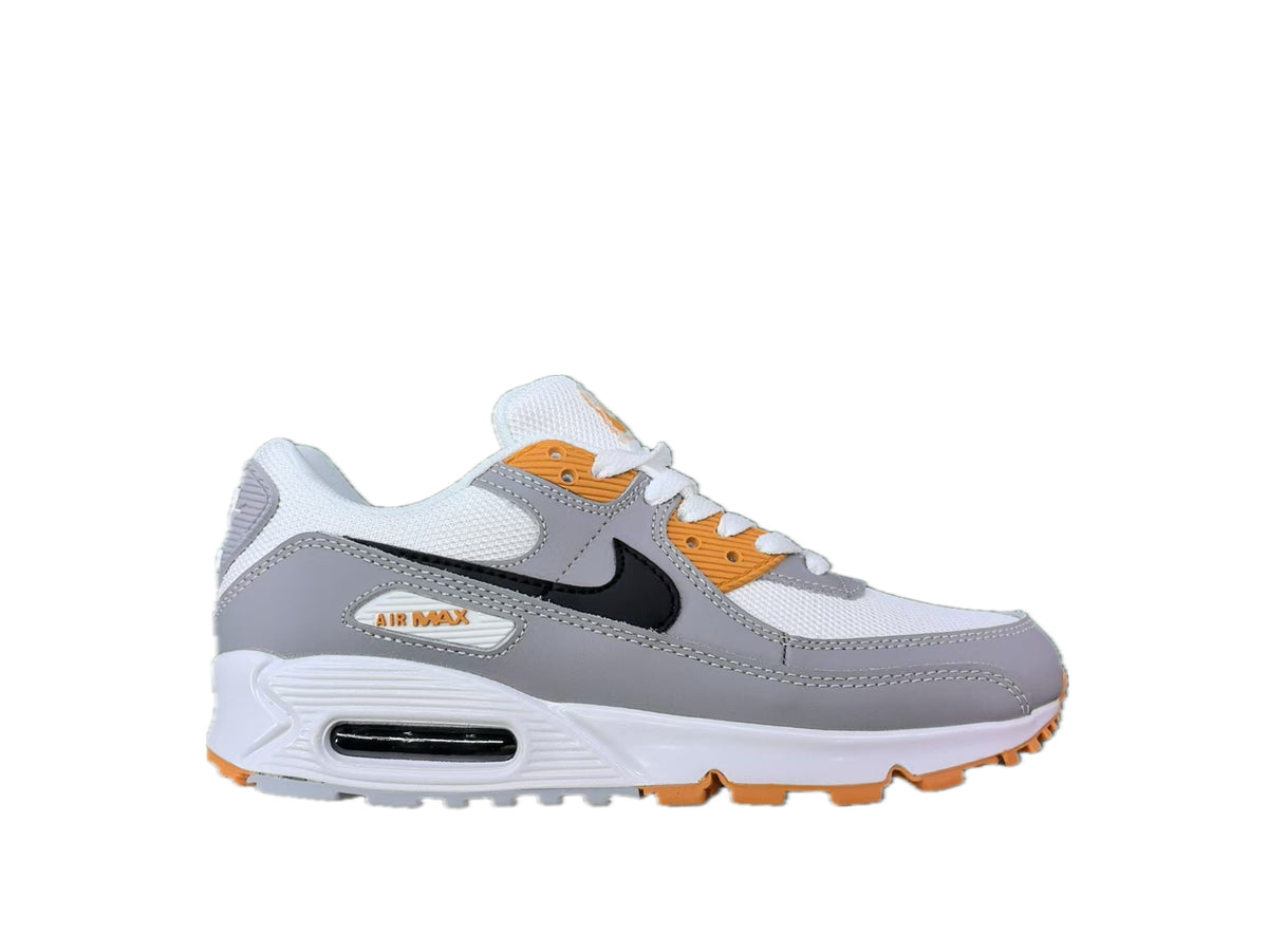 Side view of a white and grey Nike Air Max sneaker with black Swoosh and orange accents