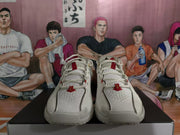 Front view of white Nike basketball shoes with perforated uppers and red lace details