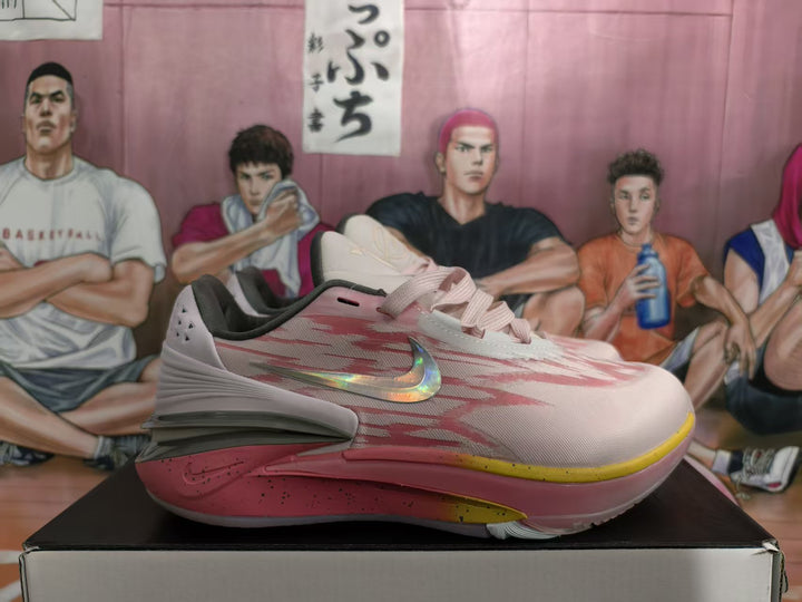 Side view of pink and white Nike basketball shoes with yellow outsole accents and a reflective-looking Swoosh detail.