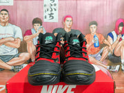 Front view of black and red Nike high-top sneakers with yellow accents and a layered black outsole.