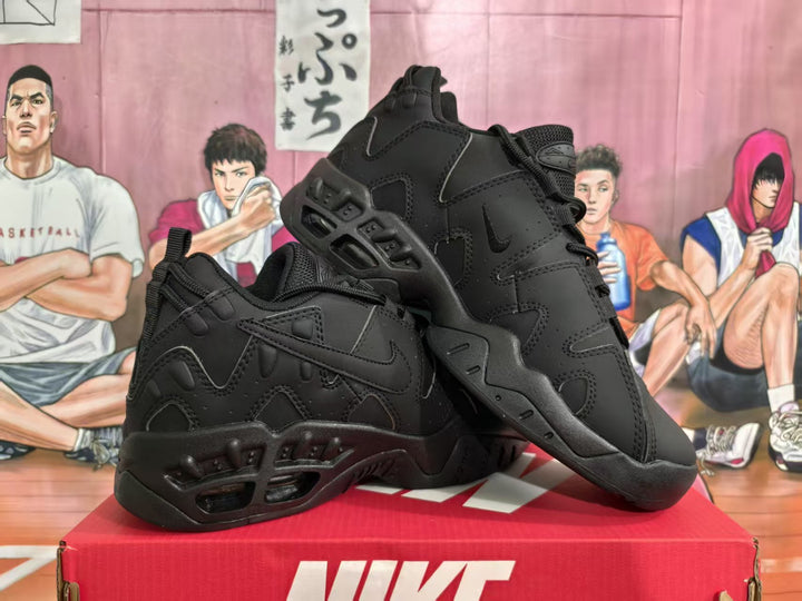 Black Nike low-top sneakers shown from the side on a red box.