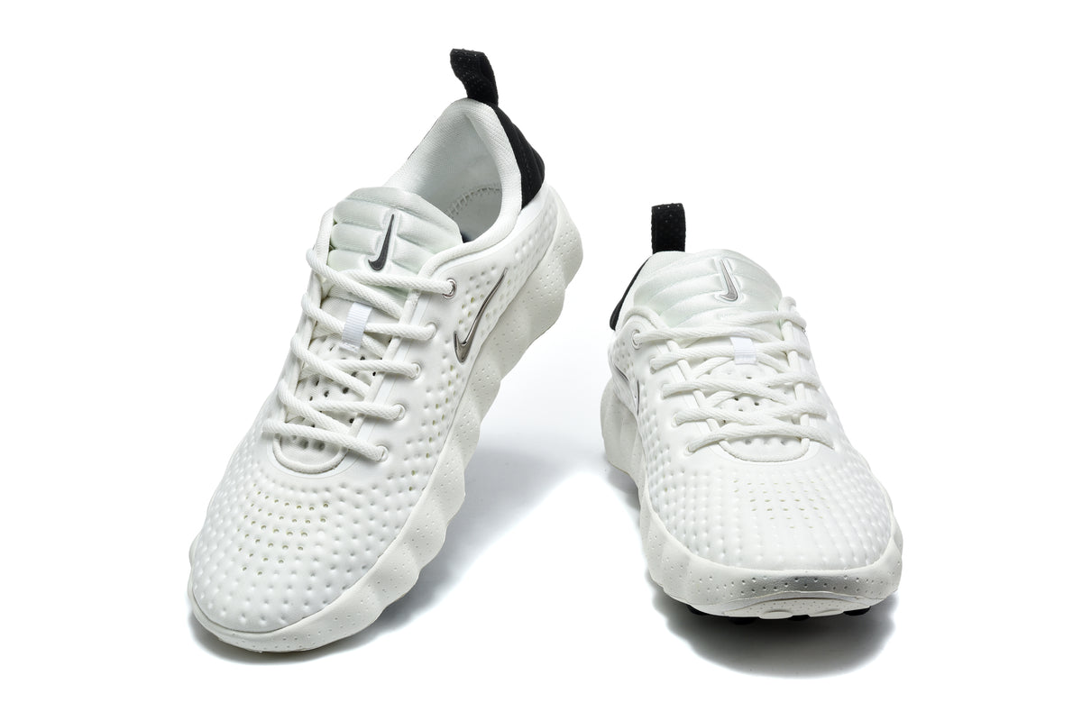 Pair of white Nike sneakers with black heel pull tabs, black side logos, and perforated uppers shown from the front.